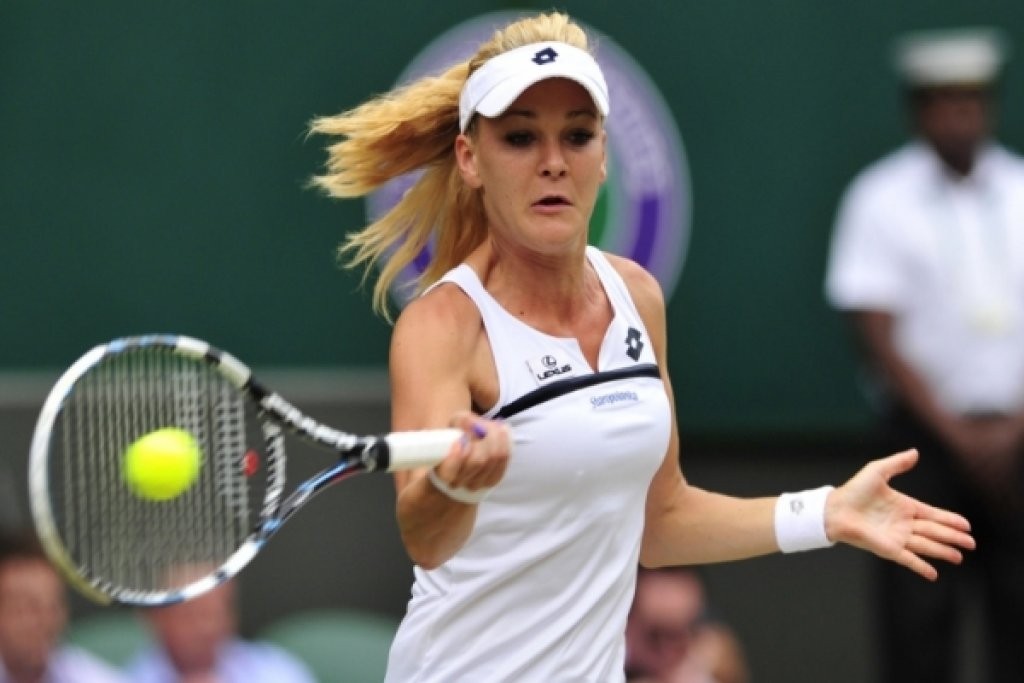 TENNIS-GBR-WIMBLEDON...Poland's Agnieszka Radwanska returns against Germany's Sabine Lisicki during their women's singles semi-final match on day ten of the 2013 Wimbledon Championships tennis tournament at the All England Club in Wimbledon, southwest London, on July 4, 2013. AFP PHOTO / GLYN KIRK - RESTRICTED TO EDITORIAL USE (Photo credit should read GLYN KIRK/AFP/Getty Images)
